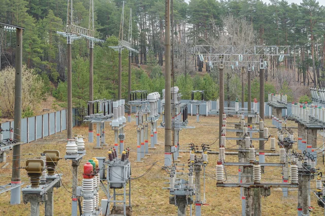 small railway high voltage electrical substation in a coniferous forest